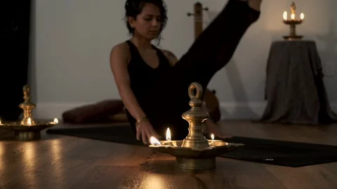 Young woman doing reverse plank yoga asana in a lamp lit studio. Stock Footage 129472183