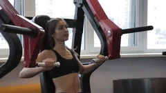 Woman trains her chest muscles on pec deck machine at the fitness centre  33876579 Stock Video at Vecteezy