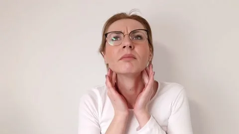 Young woman doing thyroid self examination Stock Footage 232590915