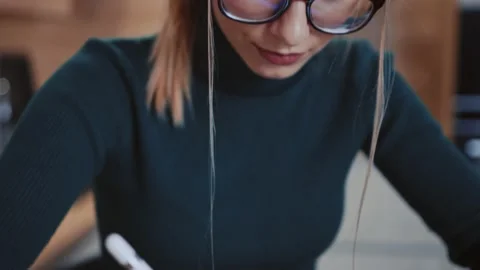 Young woman drawing at tablet computer creating illustration indoors at home Stock Footage 147002270