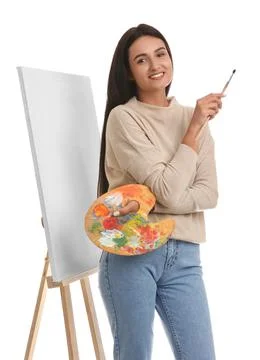 Young woman with drawing tools near easel on white background Stock Photos
