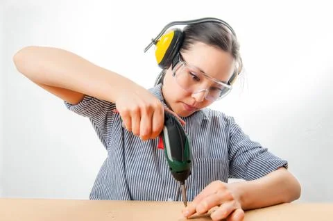 Young woman with a drill Stock Photos