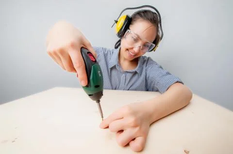 Young woman with a drill Stock Photos
