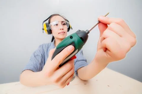 Young woman with a drill Stock Photos
