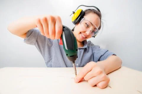Young woman with a drill Stock Photos