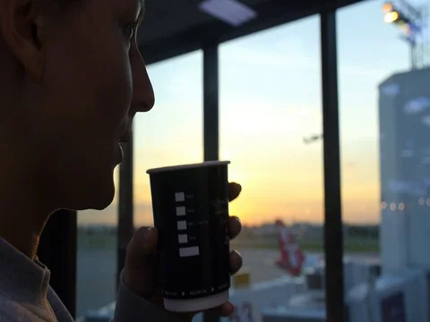 Young Woman Drinking Coffee in Airport Stock Footage