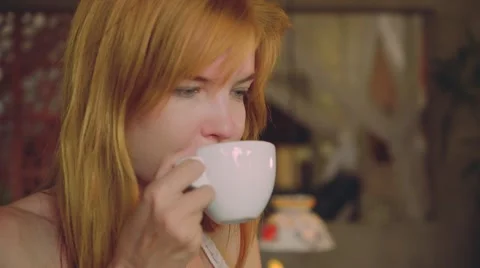 Young woman drinking coffee in rustic cafe Stock Footage 67849826