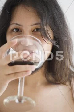 Young Woman Drinking A Glass Of Wine