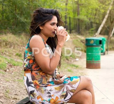 Young woman drinking a take away coffee Stock Photos