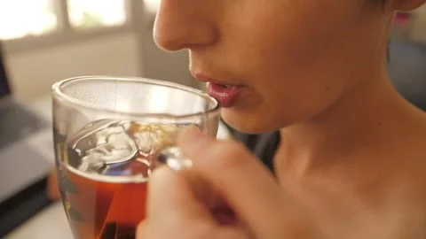 Young woman drinking tea while working on a laptop slow motion Stock Footage 281842136