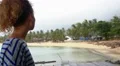 Young Woman Drinking Water in Restaurant against Palm Beach. HD Footage