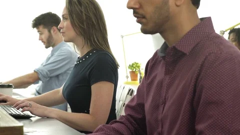 Young woman drinking while working in an office 動画素材 83396214