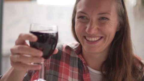 A young woman drinks red dry wine from a glas Stock Footage 110972716