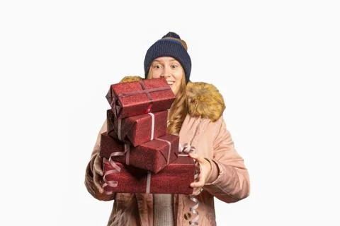 Young woman drops down a stack of christmas presents Stock Photos