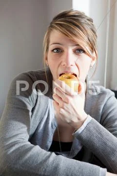 Young Woman Eating An Apple