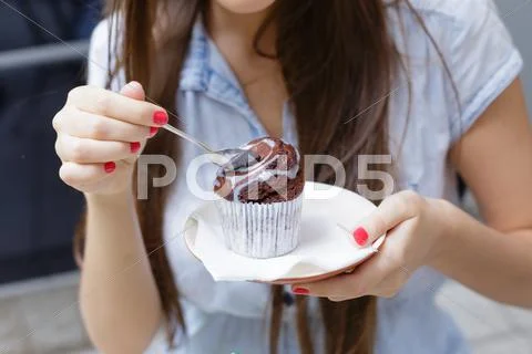 Young Woman Eating Cake In Outdoor Cafe Closeup