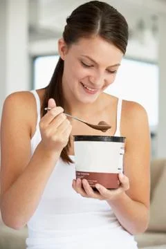 Young Woman Eating Chocolate Ice-Cream Stock Photos
