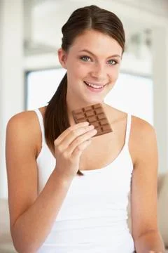 Young Woman Eating Chocolate Stock Photos