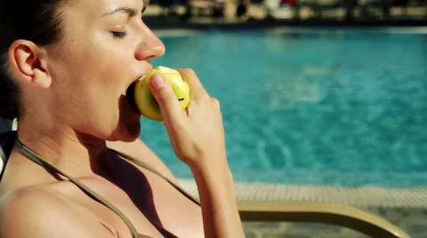 Young woman eats fresh apple outdoor Stock Footage 1089747