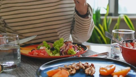 Young woman eats at table beautiful delicious breakfast in hotel, cafe Видео 212552496
