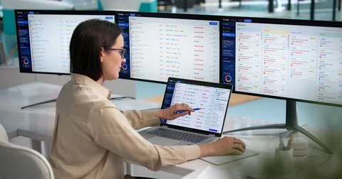Young Woman Efficiently Resolving IT Support Tickets On Laptop Screen. Stock Photos