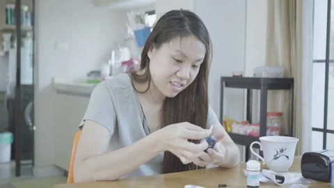 Young Woman Engaged with Small Objects at Home Stock Footage 335588369