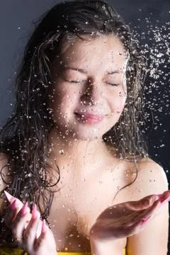 Young woman enjoy in water splashes Stock Photos