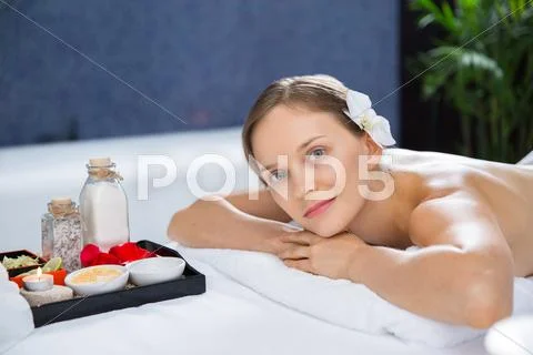 Young woman enjoying aromatherapy on massage table Stock Photos