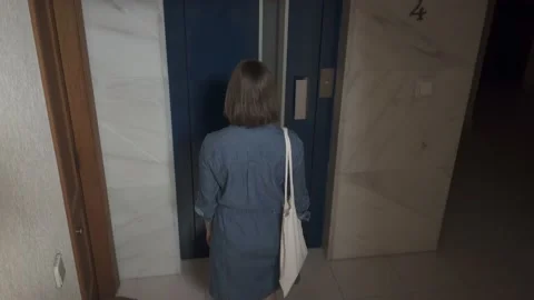 Young woman entering inside the elevator and closing the door Stock Footage 132060206
