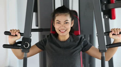 Young woman exercising on machine Stock Footage 60048170