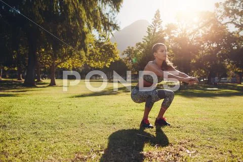 Young woman exercising in park on a nice summer day Stock Photos