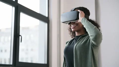 Young woman experiencing virtual reality headset at home Stock Footage 167945826
