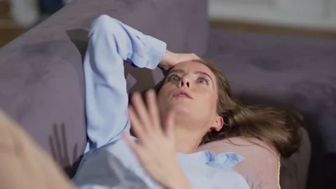 Young woman explaining problem to therapist lying on sofa Stock Footage 142380647