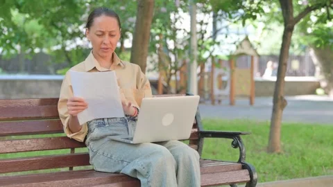 Young Woman Expressing Frustration While Working Outdoors Vídeo Stock 310596232