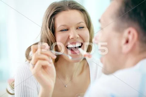 Young woman feeding her boyfriend with a fork Stock Photos