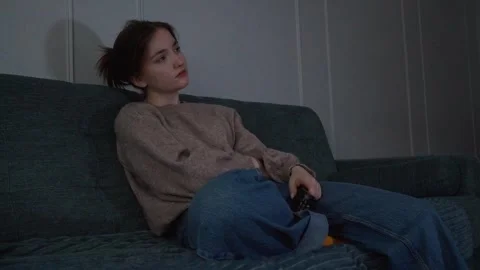 Young woman feeling bored while watching television at night Stock Footage 309768520