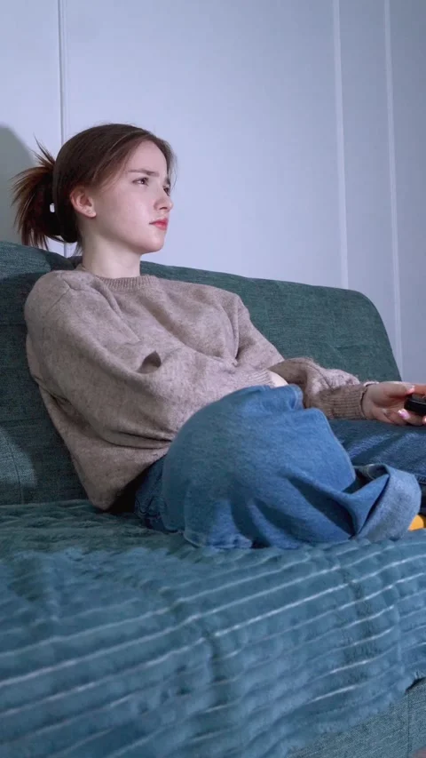 Young woman feeling bored while watching television at night Stock Footage 309768640