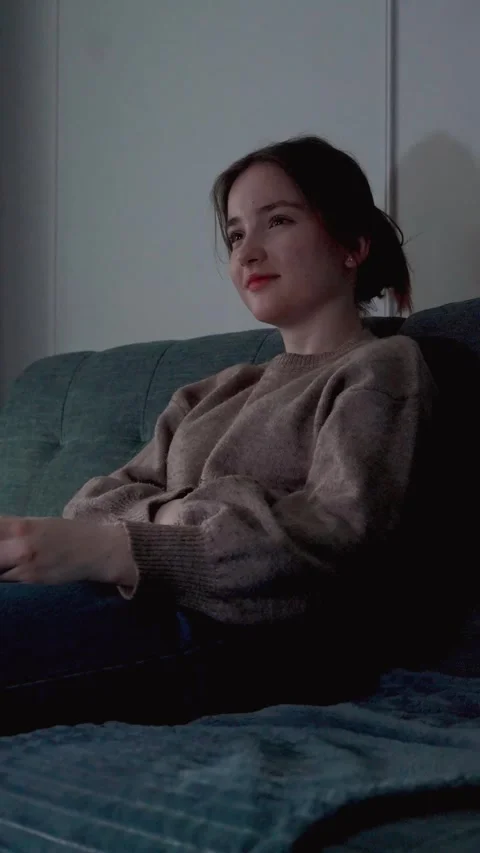 Young woman feeling bored while watching television at night 库存影片 309768715