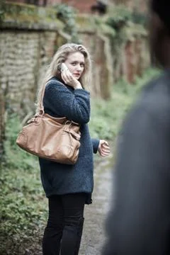 Young Woman Feeling Threatened As She Walks Home Stock Photos