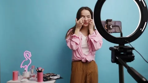 Young Woman Filming Makeup Tutorial Using Smartphone and Ring Light in Home.. Stock Footage 305979341