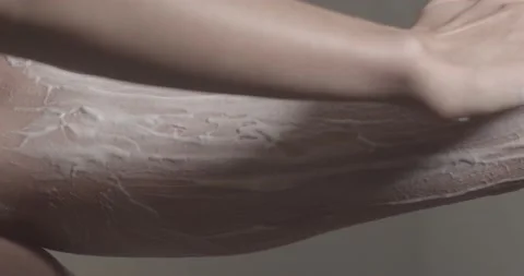 Young woman finishes applying shaving cream on leg Stock Footage