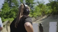 Young Woman Fires A Pistol At A Shooting Range. Stock Footage