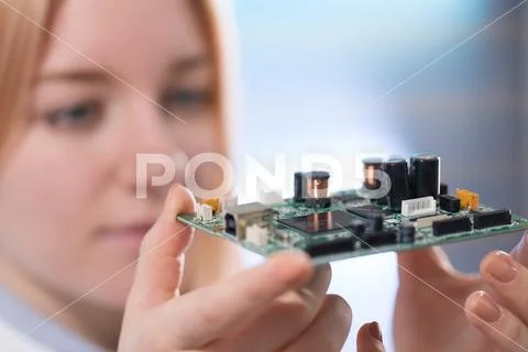 Young woman fix PC component in service center Stock Photos
