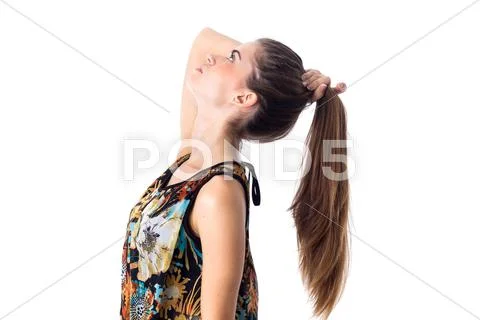 Young woman fixing her hair Stock Photos