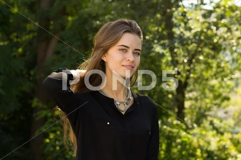 Young woman fixing her hair Stock Photos