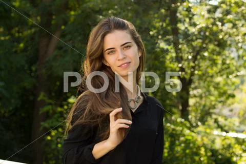 Young woman fixing her hair Stock Photos