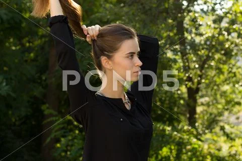 Young woman fixing her hair Stock Photos