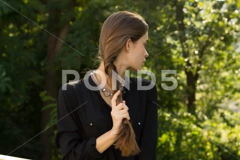 Young woman fixing her hair Stock Photos