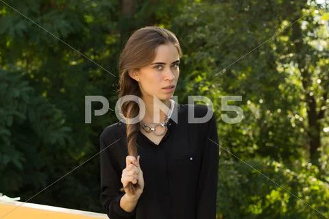 Young woman fixing her hair Stock Photos