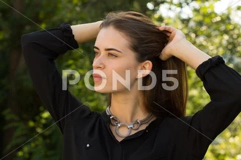 Young woman fixing her hair Stock Photos